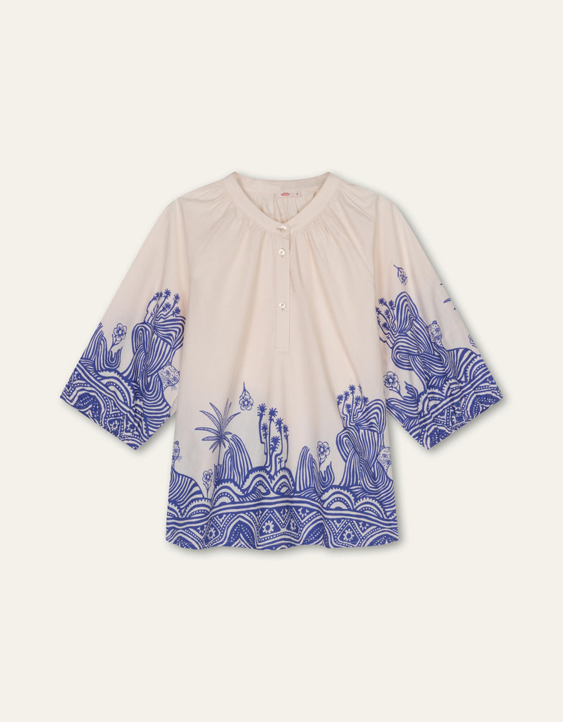 An Oilily blouse with a band collar, 3/4 sleeves with elastic, and 3 buttons at the neck for an elegant, relaxed look.